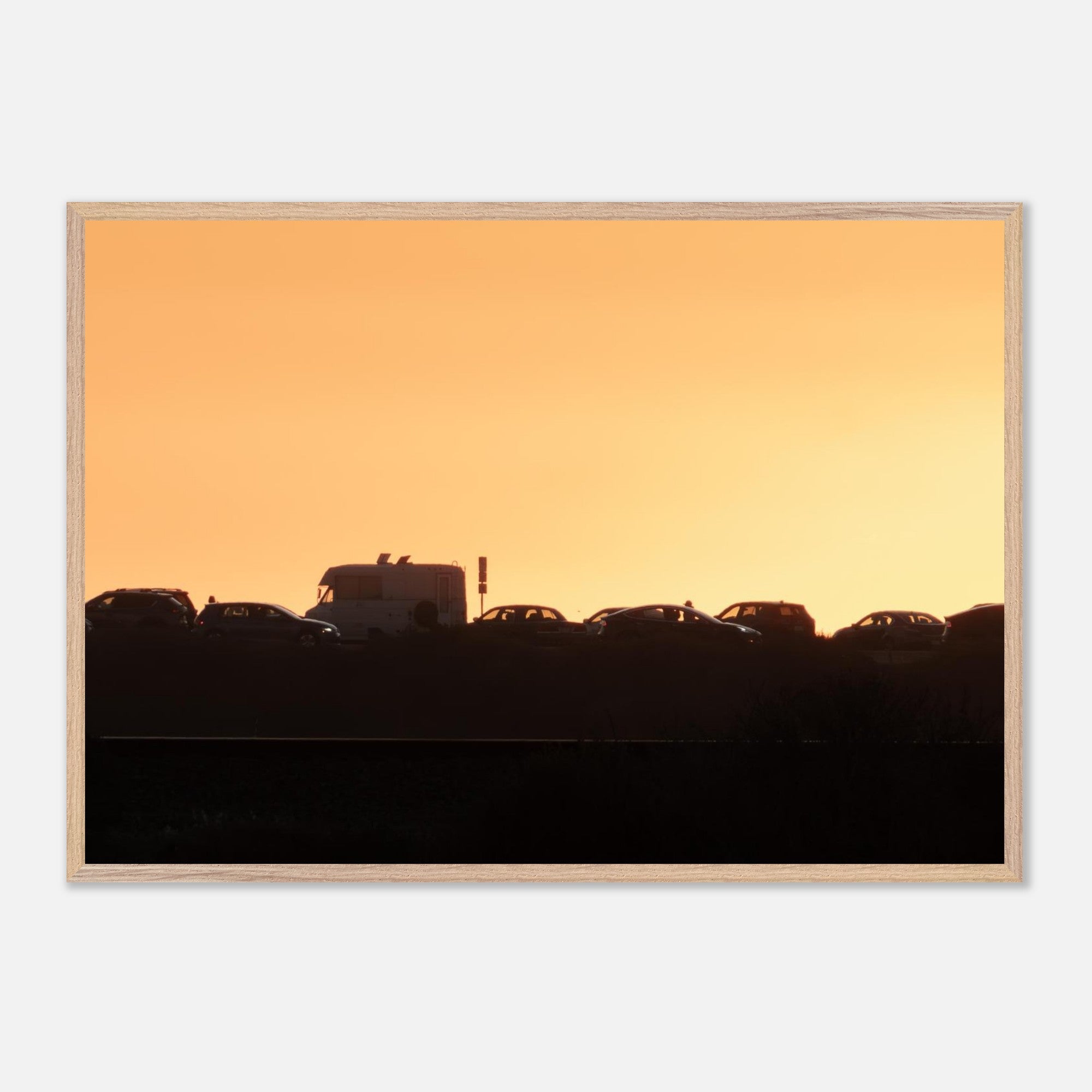 Framed Highway 101 sunset print hanging on a wall
